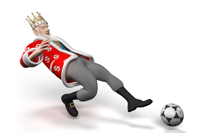 The Football King is stretching to reach the ball with his left foot.  The chances of a goal are high.
