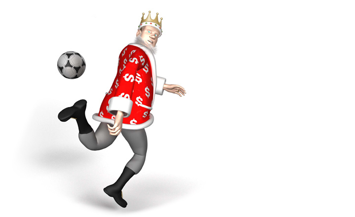 The King is doing a move with a football where he flicks it from behind.