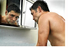 boxer oscar de la hoya is looking in the mirror - preparing for the next fight vs. steve forbes