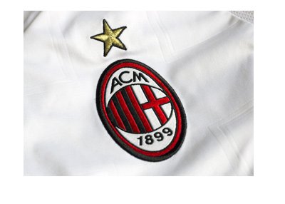 AC Milan logo / crest / badge on a pearl white shirt.