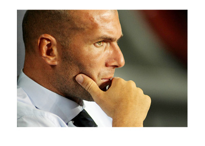 Zinedine Zidane is in deep thought, dressed up in a suit and tie