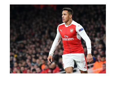 Alexis Sanchez is in action for Arsenal FC. Trademark pose.