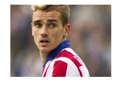 The Atletico Madrid forward Antoine Griezmann in action wearing the home colors.