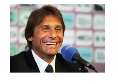 Antonio Conte with a big smile on his face. At a press conference.