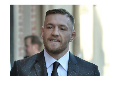 MMA master - Conor McGregor is walking down the streets of LA rocking a nice suit. Dressed up and looking good.