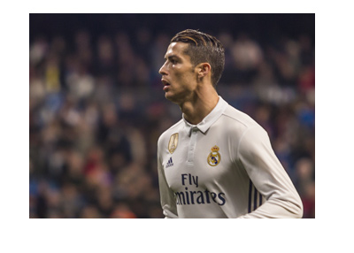 Cristiano Ronaldo in action for Real Madrid - The year is 2017 - White home kit with a winning badge imprinted in golden yellow.