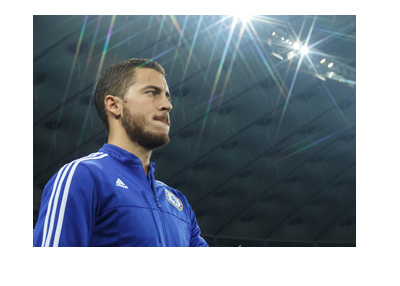 Eden Hazard is walking out onto the pitch. Under the spotlight.