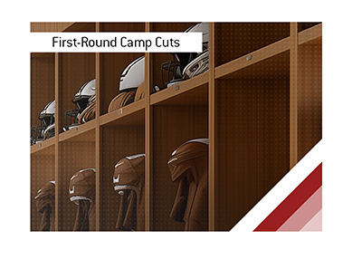 NFL training camp locker room with rows of fully equipped lockers surrounding a single empty locker.