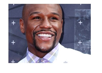 In the spotlight. Floyd Mayweather. Wearing the white suit.