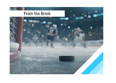 Hockey puck resting near goal crease during Game 7 moment.