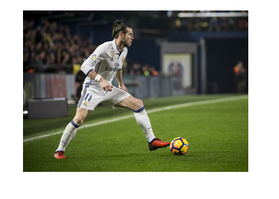 Real Madrid winger, Gareth Bale, is on the move with the ball.  The year is 2017.