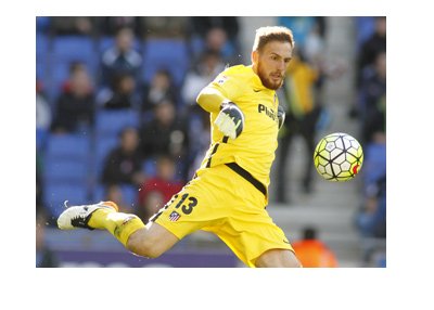 Jan Oblak, Atletico Madrid number one, is kicking the ball from the yard box.