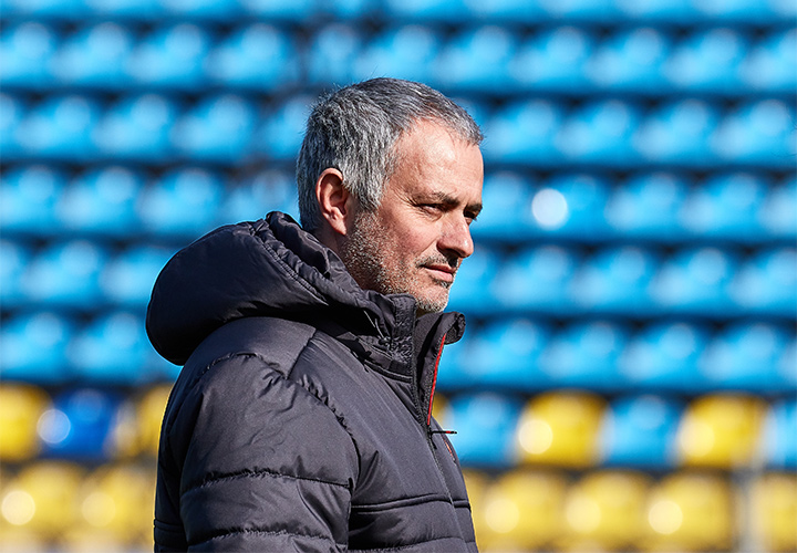 The Manchester United manager, Jose Mourinho, is sporting a winter adidas jacket and a serious / focused look on his face. The stands are empty. Training.
