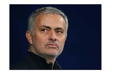 Jose Mourinho is looking into the distance. Smirking perhaps.