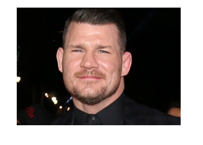 The spotlight is on the current welterweight UFC champion - Michael Bisping. The champ is wearing a dark suit.