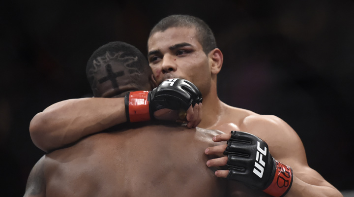 Two fighteres embracing in a friendly hug after a grueling mixed martial arts fight.
