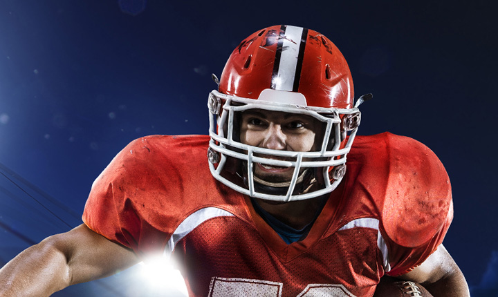 The action shot of American football players in action. How to bet on the game.