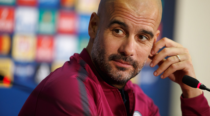 Manchester City manager, Pep Guardiola, with a half smile during a press conference after a Champions League match.  The season is 2017/18 and his team are the favourites to win the tournament coming into the round of 16.