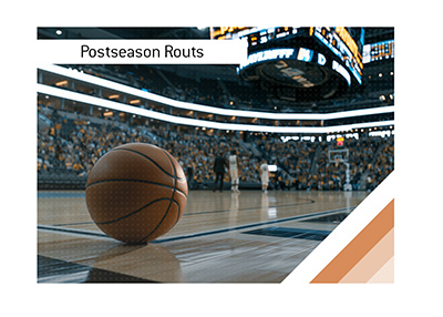 Basketball resting on NBA playoff court with blurred scoreboard and arena crowd background.