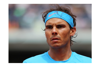 Rafael Nadal photographed at the French Open tennis tournament.  Deep focus.