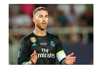 Real Madrid captain, Sergio Ramos, is cheering his team on.  Wearing the away kit and clapping.  Mid game photo.