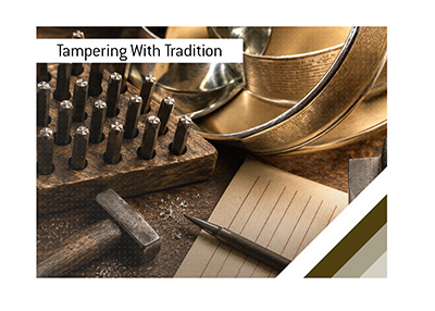 Traditional hand engraving tools and engraved championship trophy bands on a craftsmans workbench.