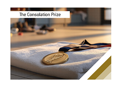 Bronze football medal resting on a folded white towel in a quiet locker room.