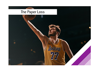 Luka Doncic wearing his number 77 Lakers jersey while reaching toward the basket for a layup.