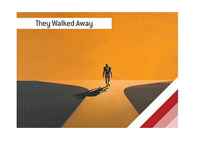 American football player walking away at a forked path.