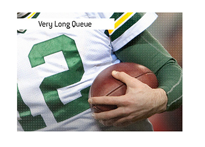 There is a very long queue for the Green Day Packers season tickets.  In photo:  Team legend Aaron Rodgers with the ball.
