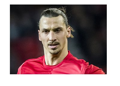 Zlatan Ibrahimovic sporting the Manchester United bright red home kit.  Year is 2017.  Signature pose.