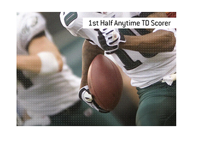 First Half Anytime Touchdown Scorer betting term is defined.  What does it mean?  In photo:  A Philadelphia Eagles player is running across the line.