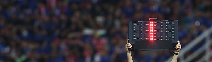 Soccer referee holding up a Added / Injury Time sign signalling one minute of added time.