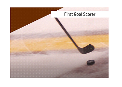 Hockey betting term First Goal Scorer is explained.  In photo:  Boston Bruin player with the puck.