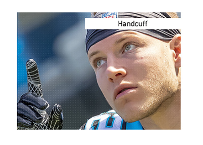 In photo: Christian McCaffrey pointing the finger up.  The meaning of the American football term Handcuff is explained when it comes to playing Fantasy part of the game.