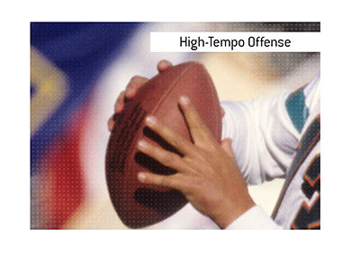 American football term High-Tempo Offense is explained and examples are provided.  In photo:  Miami Dolphins legendary player Dan Marino about to launch the ball.