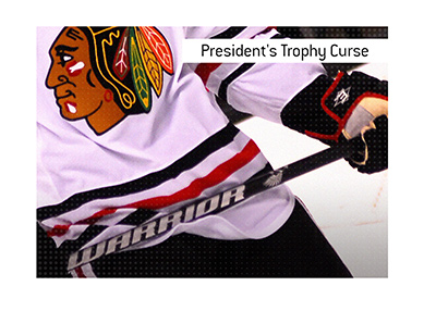 The meaning of the hockey term Presidents Trophy Curse is explained.  What is it in the NHL?  IN photo:  Chicago Blackhawks player in action.  Bet on it!