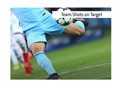 Manchester City player is taking a shot on goal.  The meaning of the term Team Shots on Target is explained, when it comes to sports wagering.